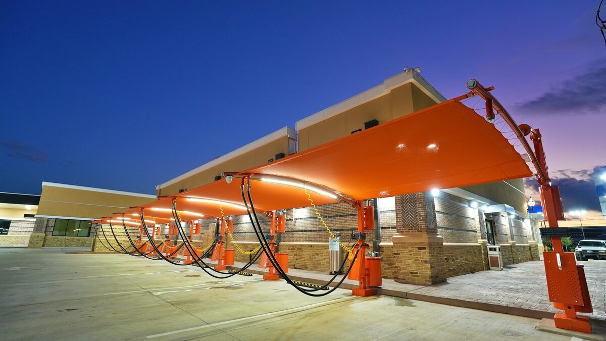 Spark Carwash orange shade canopy at twilight